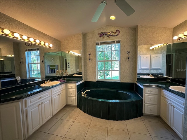 bathroom featuring a bath, ceiling fan, dual bowl vanity, and tile patterned flooring