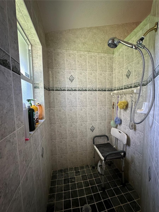 bathroom with a tile shower