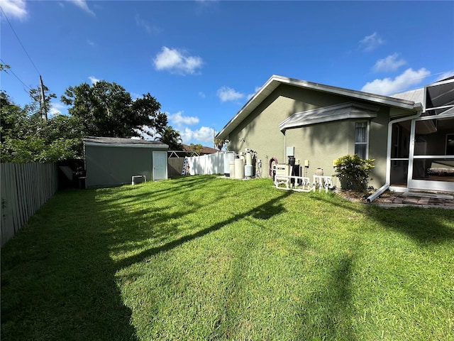 view of yard featuring a storage unit and a sunroom