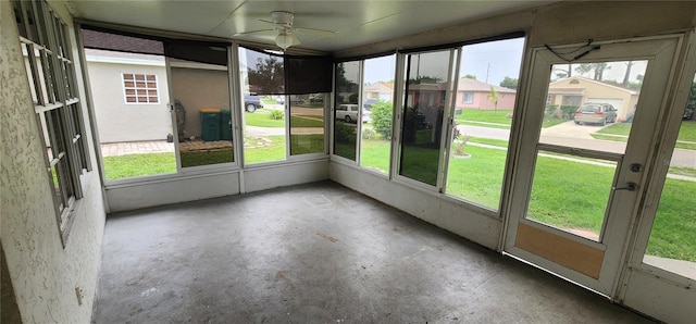 unfurnished sunroom with ceiling fan and a wealth of natural light