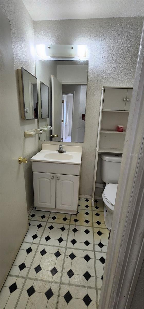 bathroom featuring toilet and vanity