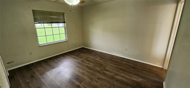 spare room featuring ceiling fan and dark wood-type flooring