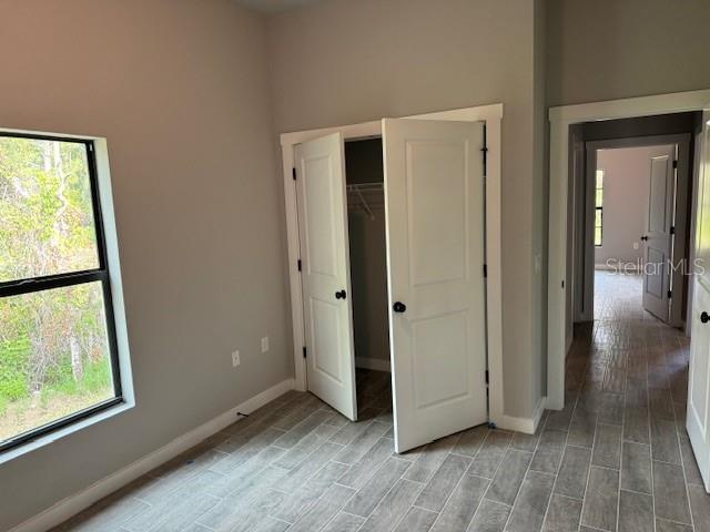 unfurnished bedroom with light hardwood / wood-style floors and a closet