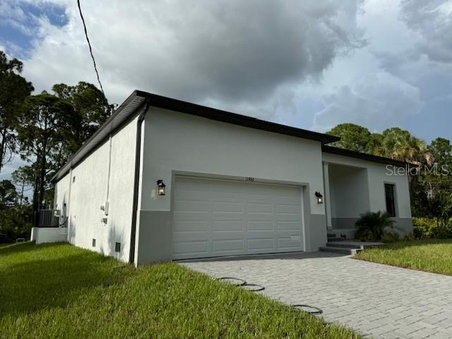 exterior space with a garage and a yard