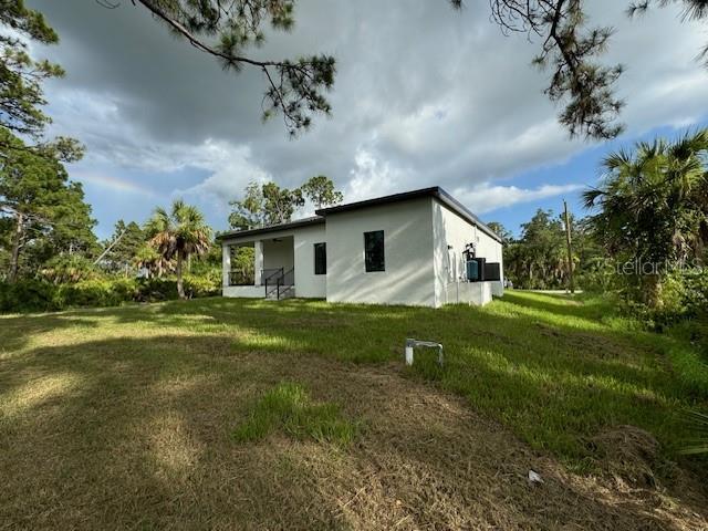 rear view of house with a lawn