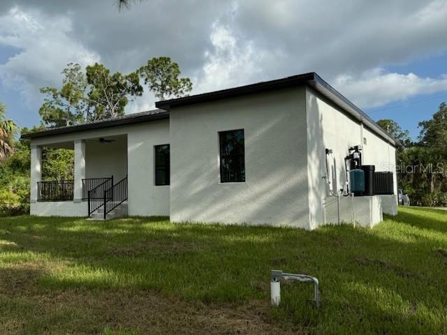 back of house with a porch and a lawn