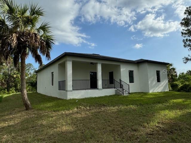 rear view of property with a yard