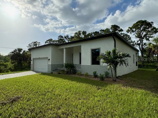 view of front of property with a garage and a front lawn