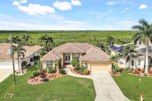 view of front of house featuring a garage, solar panels, and a front lawn