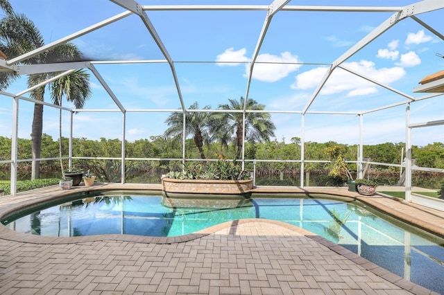 view of pool with a patio and a lanai