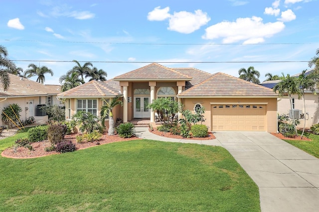 single story home with a garage, french doors, and a front lawn