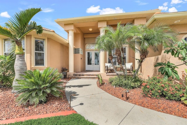 view of exterior entry featuring french doors