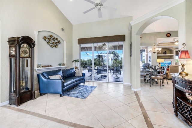 tiled living room featuring ceiling fan with notable chandelier