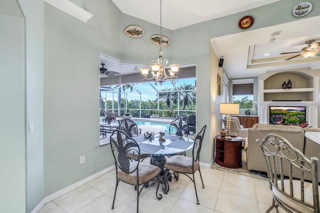 dining area featuring light tile patterned floors, built in shelves, a raised ceiling, and ceiling fan