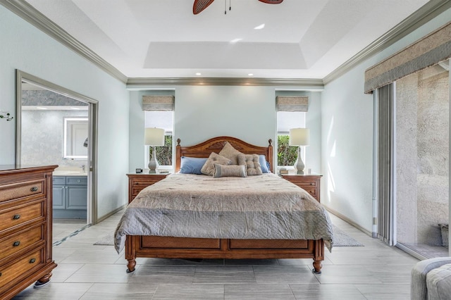 bedroom with ensuite bathroom, crown molding, ceiling fan, and a tray ceiling