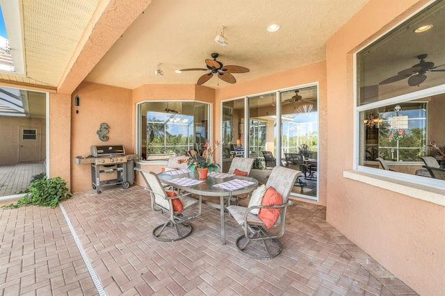 view of patio with a grill and ceiling fan