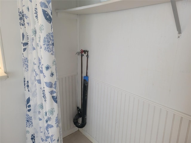 bathroom with a wainscoted wall