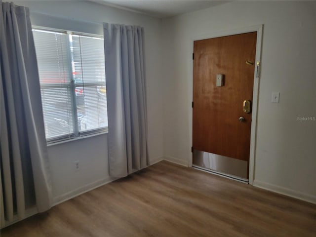 interior space featuring baseboards and wood finished floors