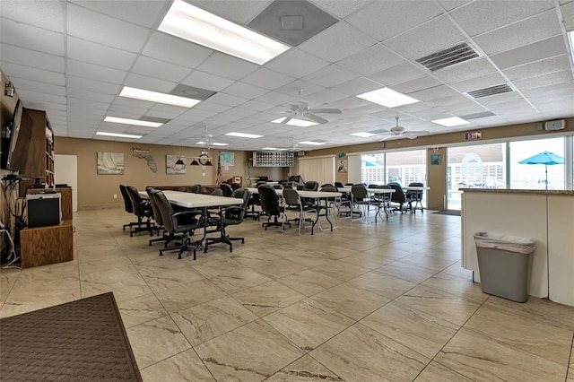 dining space featuring visible vents and a drop ceiling