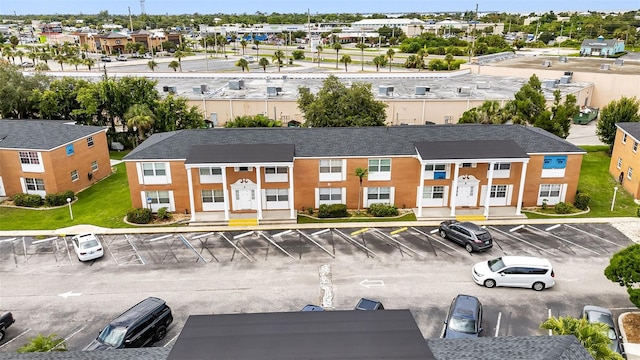 view of property with a residential view and uncovered parking