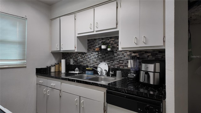 kitchen featuring white cabinets, backsplash, and sink