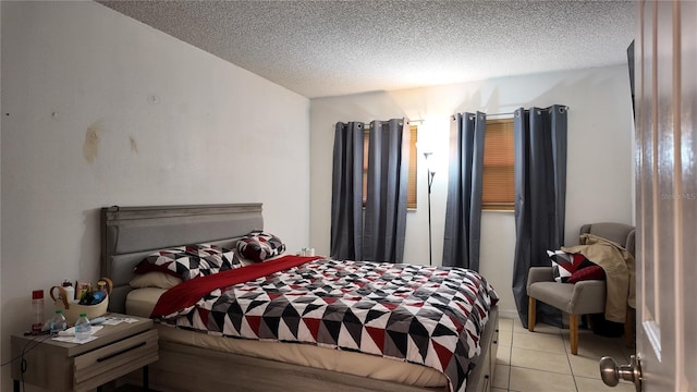 bedroom featuring a textured ceiling and light tile patterned flooring