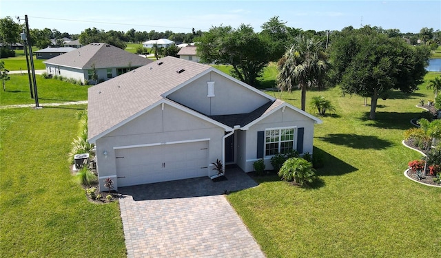 ranch-style house featuring a front yard and a garage