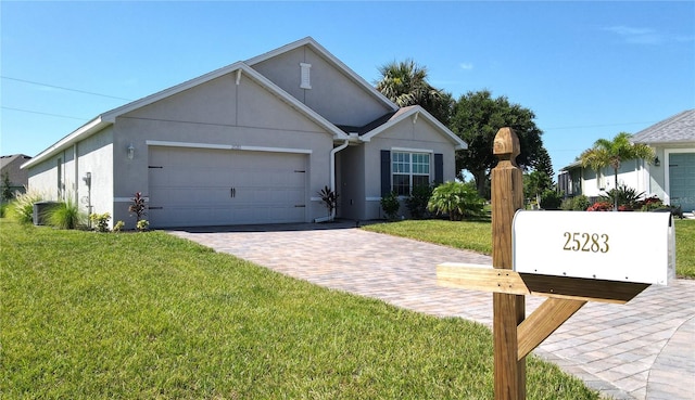 ranch-style home featuring a garage and a front yard