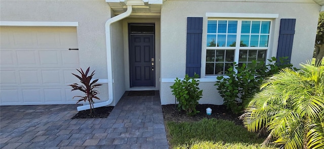 view of exterior entry with a garage