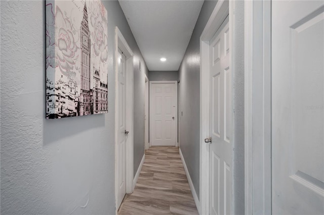 corridor with light wood-type flooring