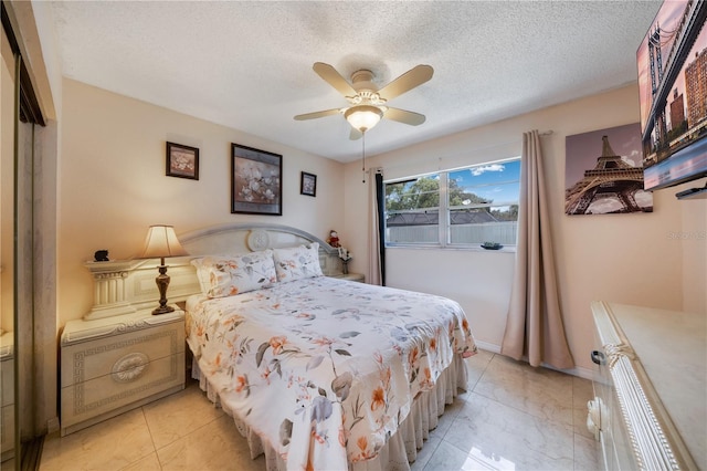 bedroom with a closet, ceiling fan, and a textured ceiling