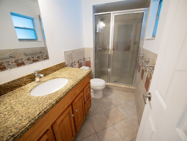 bathroom with tile patterned flooring, toilet, a shower with door, and vanity