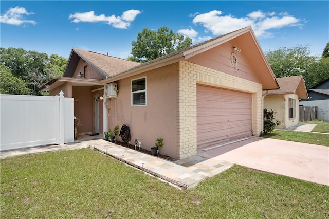 ranch-style home featuring a garage and a front lawn