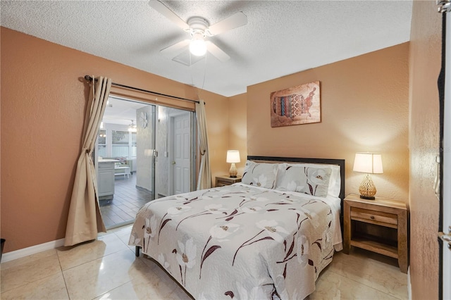 tiled bedroom with ceiling fan and a textured ceiling