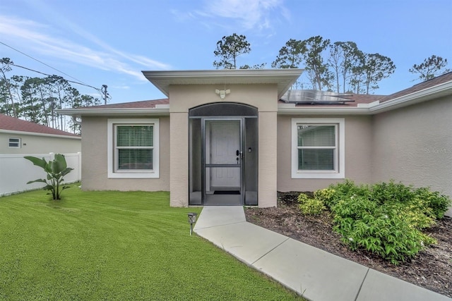 property entrance featuring a yard