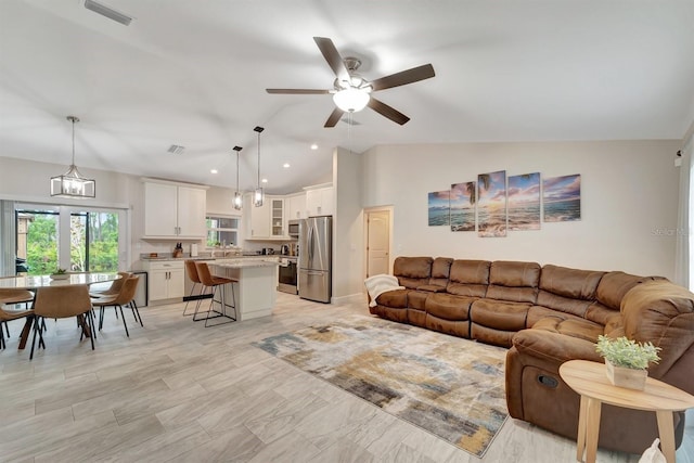 tiled living room with lofted ceiling and ceiling fan