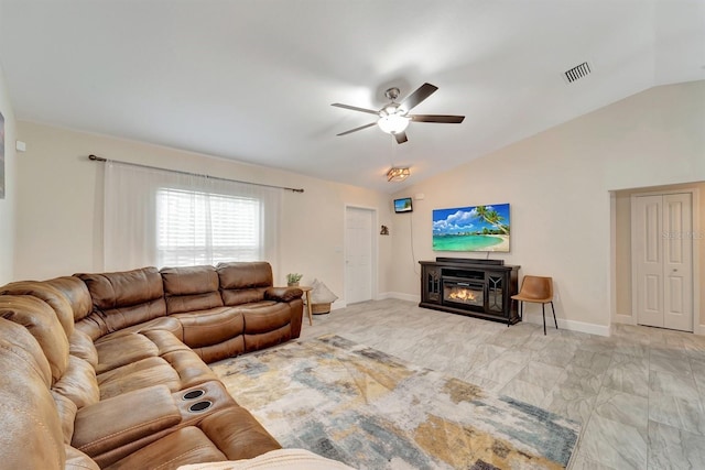 tiled living room with ceiling fan and lofted ceiling