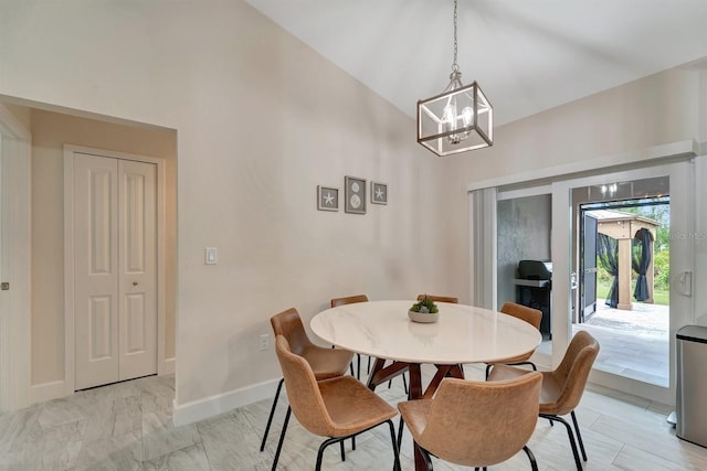 dining area featuring an inviting chandelier, high vaulted ceiling, and light tile patterned floors