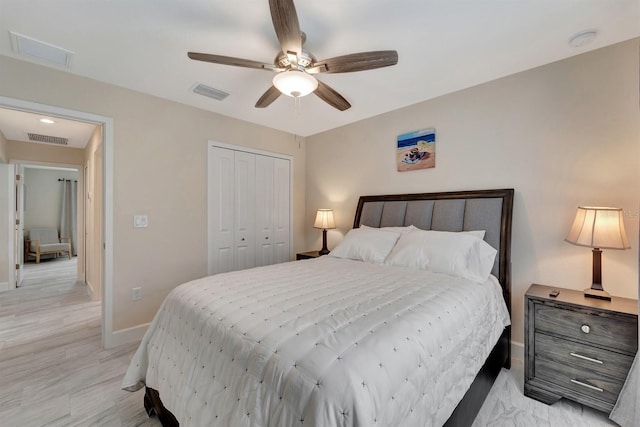 bedroom featuring ceiling fan, light hardwood / wood-style floors, and a closet