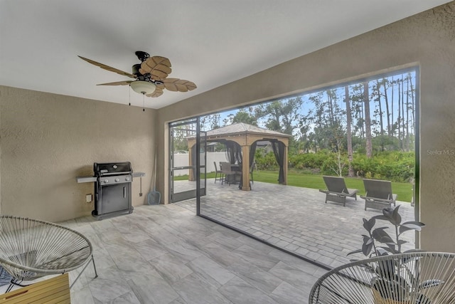 view of patio with area for grilling and a gazebo