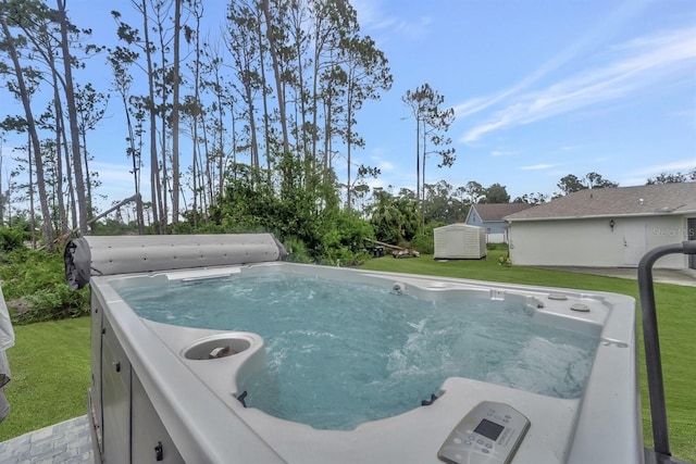 view of swimming pool featuring a lawn and a hot tub