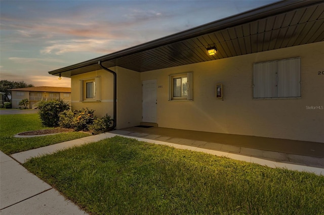 exterior space featuring a yard and stucco siding