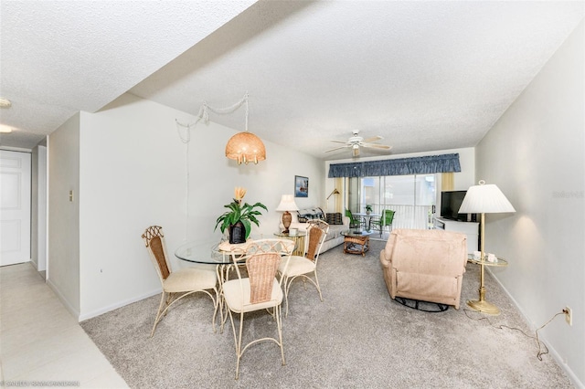 living room with ceiling fan and a textured ceiling