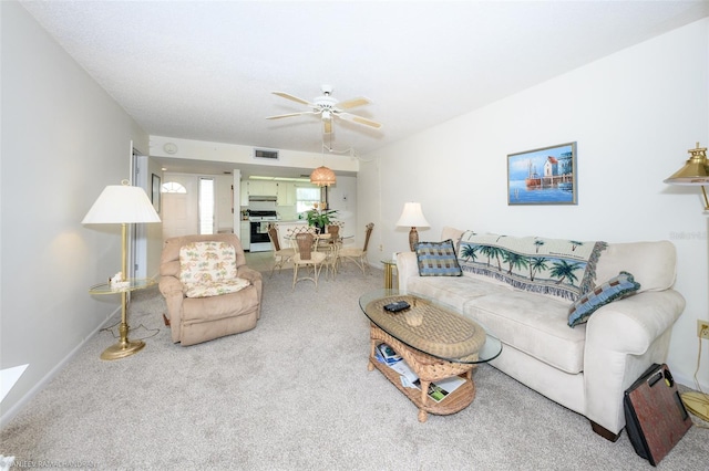 living room with carpet flooring and ceiling fan