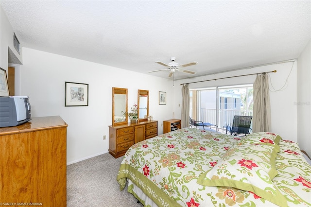 bedroom featuring a textured ceiling, access to exterior, carpet flooring, and ceiling fan