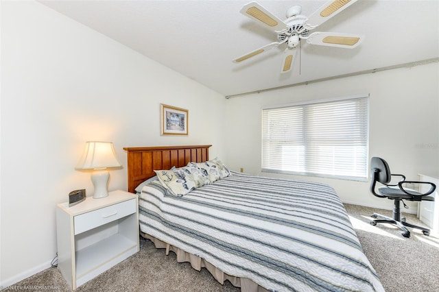 carpeted bedroom with vaulted ceiling and ceiling fan