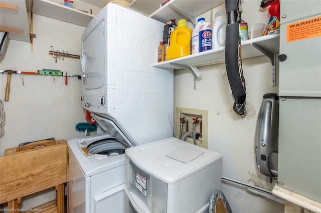 clothes washing area featuring stacked washer and dryer