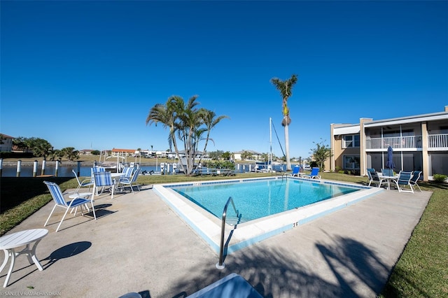 view of swimming pool featuring a yard and a patio area