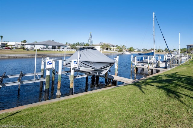 view of dock featuring a water view and a yard