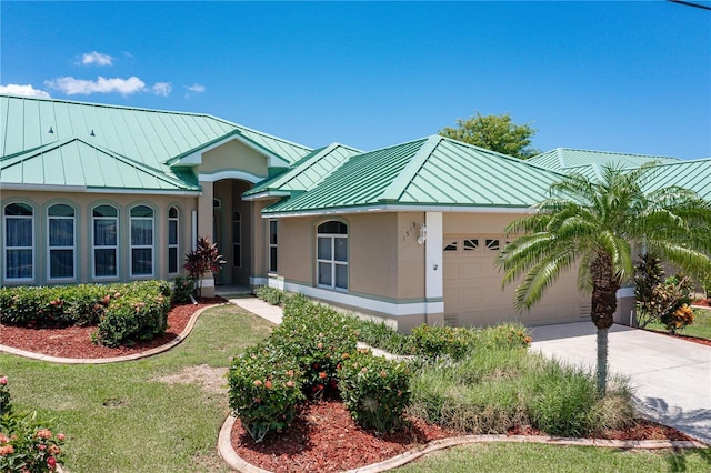 view of front of property with a garage and a front yard